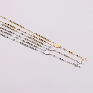 Set of four stainless steel rosary necklaces with crucifix pendants in gold and silver
