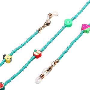 Detail of beaded glasses strap with colorful clay fruits and gold lobster clasps