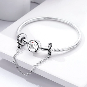 Detail of silver S925 snake chain bracelet with Family is Forever engraved pendant