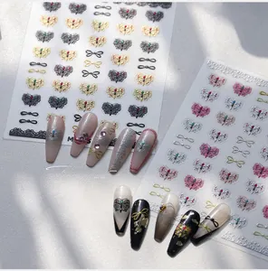 Detailed view of 3D bow and butterfly nail art stickers with metallic finish effects