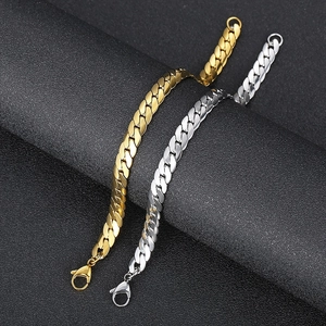 Detail view of gold and silver stainless steel Cuban link bracelets with lobster clasps