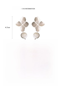 Detailed view of metal flower earrings with freshwater baroque pearls and silver needles