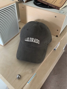 Detailed top-down view of dark grey cotton baseball cap with white Colorado embroidery