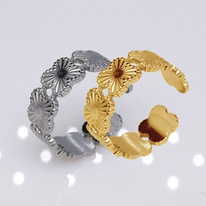 Detailed view of adjustable open rings in gold and silver finish with shell pattern