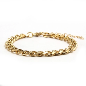 Detail of gold Cuban link bracelet featuring a secure lobster clasp and extension chain