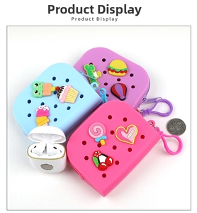 Flat lay of pink, blue and purple silicone coin purses with cartoon charms and carabiner