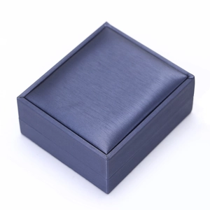 Macro shot of dark blue jewelry gift box with elegant brushed silk satin texture finish