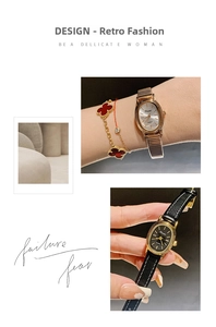 Detail of oval quartz watches with rose gold mesh band and black leather strap