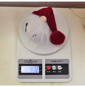 Detailed view showing the weight of a Christmas gnome bell on a digital scale