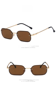 Detail of vintage gold metal sunglasses with braided temples and rectangular brown lenses