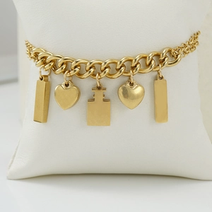 18K gold plated stainless steel bracelet with heart and rectangle charms on white pillow