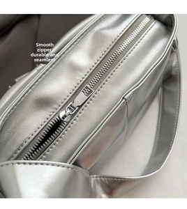 Detailed close-up showing the smooth silver metal zipper on this stylish PU leather bag