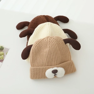 Detailed knit texture of baby hats with cute puppy ears in various neutral colors