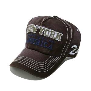 Detail of New York embroidery and white number 28 on a brown washed cotton baseball cap