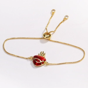 Gold adjustable bracelet featuring a red heart pendant with golden flame details and crystals