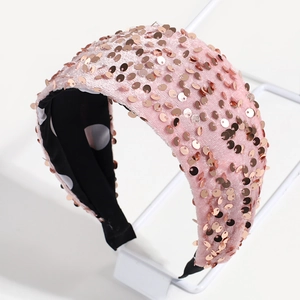 Detailed view of pink velvet headband with shimmering rose gold sequins and polka dot lining