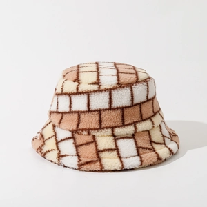 Close-up of thick checkered sherpa fleece fabric texture on a warm winter bucket hat