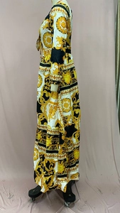 Detail view of Baroque gold print on a long-sleeved V-neck maxi dress for women