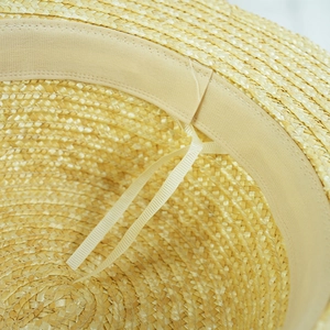 Detail of the inner adjustable strap and breathable sweatband on the straw sun hat