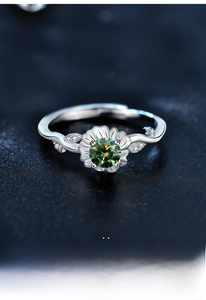 Macro detail of S925 silver sunflower ring with green moissanite and adjustable band