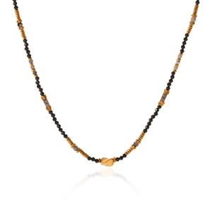 Detail of colorful beaded necklace with black, gold, and grey beads and twisted gold pendant