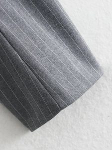 Macro detail of gray fine striped fabric showing precise stitching and woven texture