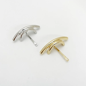 Detailed view of U-shaped gold and silver metal hair accessories with smooth plated finish