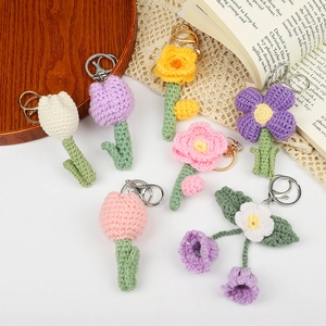 Handmade crochet flower keychains featuring colorful tulips and roses with metal rings