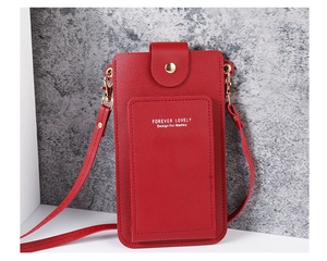 Detail of red PU leather phone crossbody bag showing golden magnetic buckle and strap