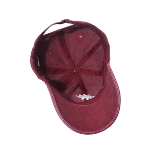 Detailed inner view of maroon baseball cap featuring adjustable metal buckle and stitching