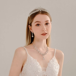 Exquisite bridal jewelry set with silver tiara, necklace and earrings on a model
