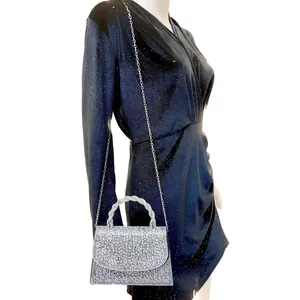 Elegant silver rhinestone evening handbag with twisted handle and silver metal chain