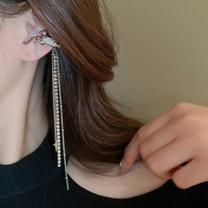 Silver winged star tassel ear cuff with rhinestones worn by a fashion model