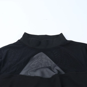 Close-up of high neck black dress featuring a triangular sheer mesh panel at the chest
