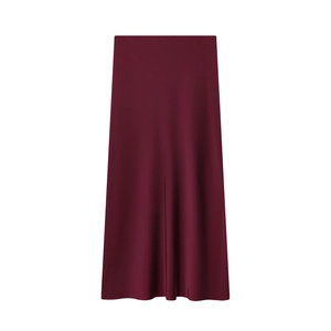 Detailed flat lay of a burgundy satin midi skirt showing smooth texture and sheen