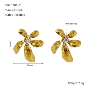 Detail view of 33mm gold floral stud earrings in stainless steel with crystal center