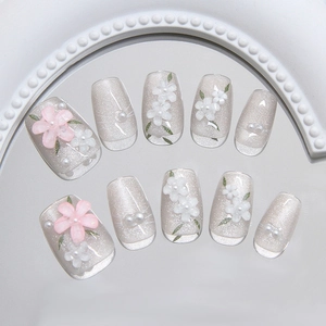 Handmade cat eye press-on nails with 3D floral accents and small pearls