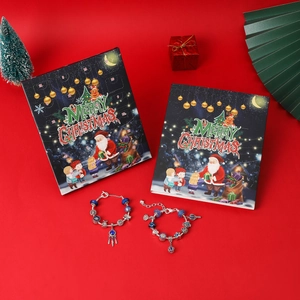 Detailed view of blue Christmas countdown calendar boxes with DIY beaded charm bracelets