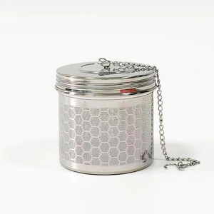 Macro detail of 304 stainless steel tea infuser with hexagonal mesh and metal chain hook