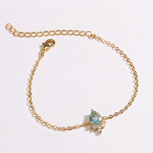 Minimalist gold-plated unicorn rainbow bracelet with a blue teardrop stone and white crystals