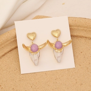 Macro view of bull skull earrings with purple gemstone on a S925 silver needle card