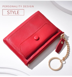 Detail of red leather coin purse with lychee texture and gold keychain ring