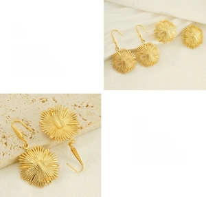 Detailed macro view of gold flower earrings with polished finish and ray texture