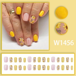 Short square press-on nails with retro sunflower art and stripes in yellow and pink