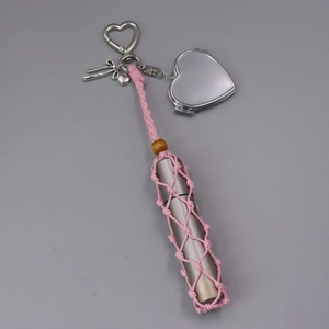 Dettaglio mini borsa a rete rosa con specchio a cuore e porta rossetto
