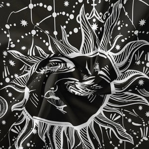 Macro detail of Bohemian moon sun tapestry showing fine fabric texture and celestial print