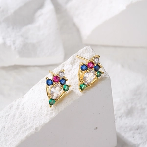 Elegant geometric gold-plated stud earrings with colorful zircon stones on a white stone base
