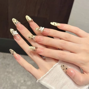 Handmade almond press-on nails with leopard French tips and 3D resin cat bow charms