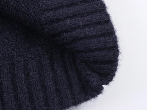 Macro shot of dark blue rib-knit cuffs showing soft wool blend fabric texture