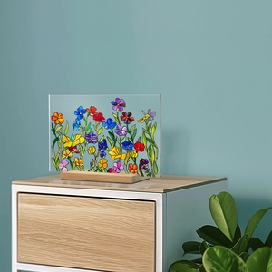 Detail of floral acrylic plaque with stained glass effect on a wooden stand